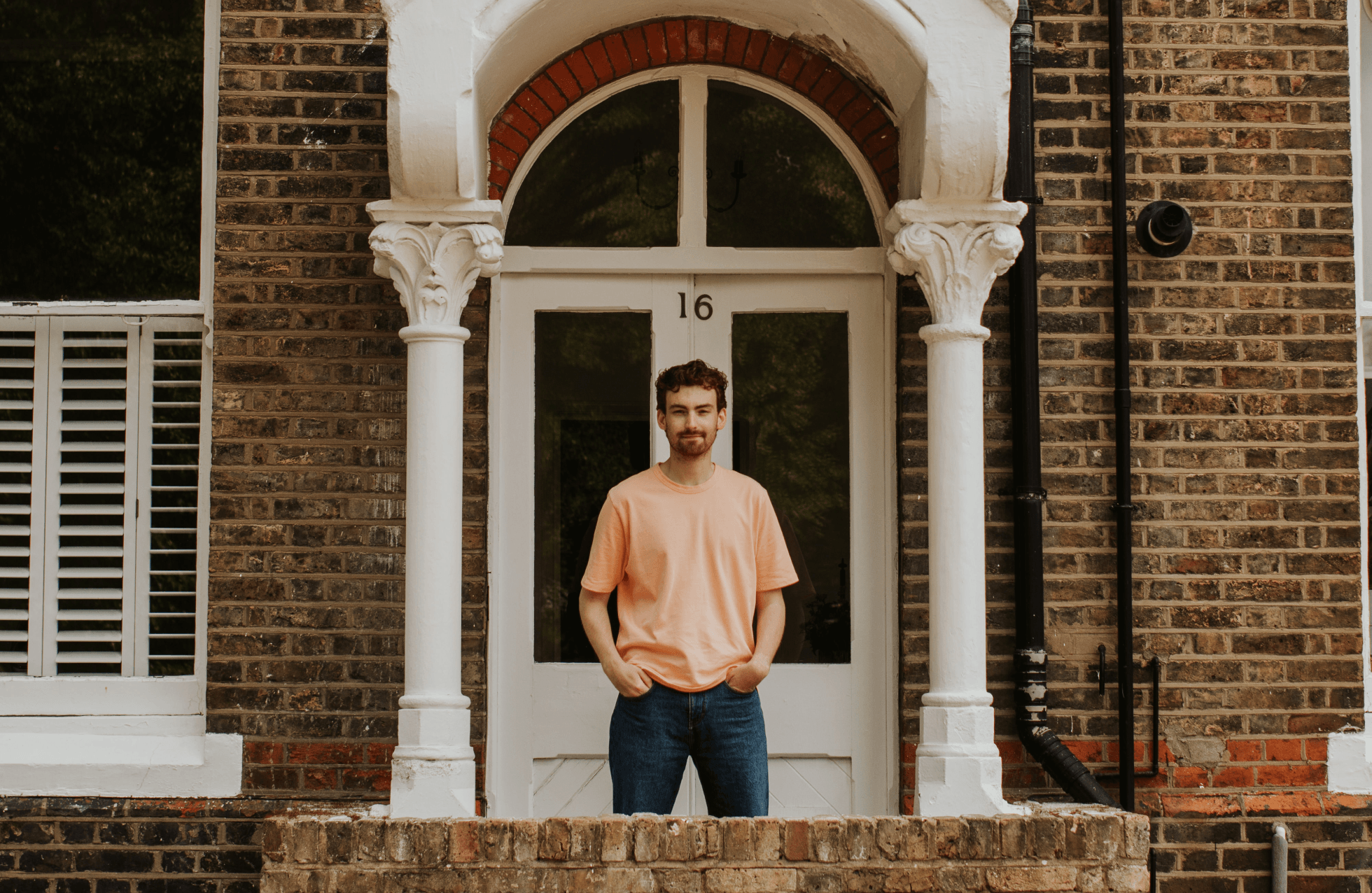 Photograph of Tom Wicks in an orange tee shirt